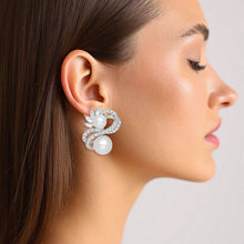 Load image into Gallery viewer, PinktownUSA - Clip On High End Silver Ribbon Pearl Earrings: Color: White / Plating: Rhodium / Size: 1.5 x 1.25 inches
