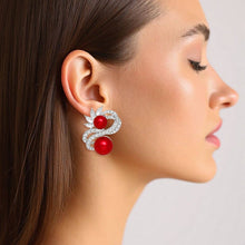 Load image into Gallery viewer, PinktownUSA - Clip On High End Silver Ribbon Red Pearl Earrings: Color: Red / Plating: Rhodium / Size: 1.5 x 1.25 inches
